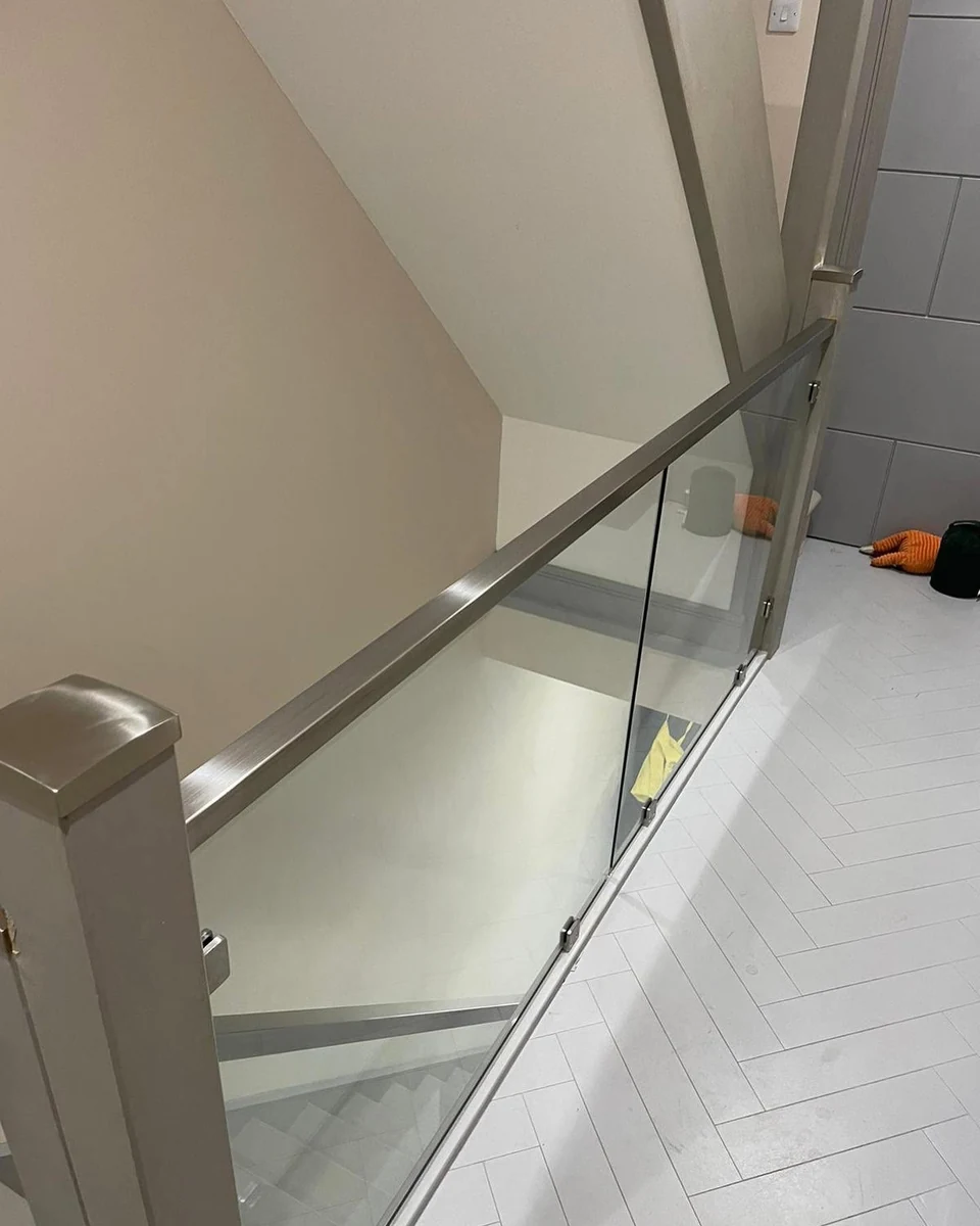 Steel cap post glass balustrade at staircase landing, Maidstone Glass Balustrades